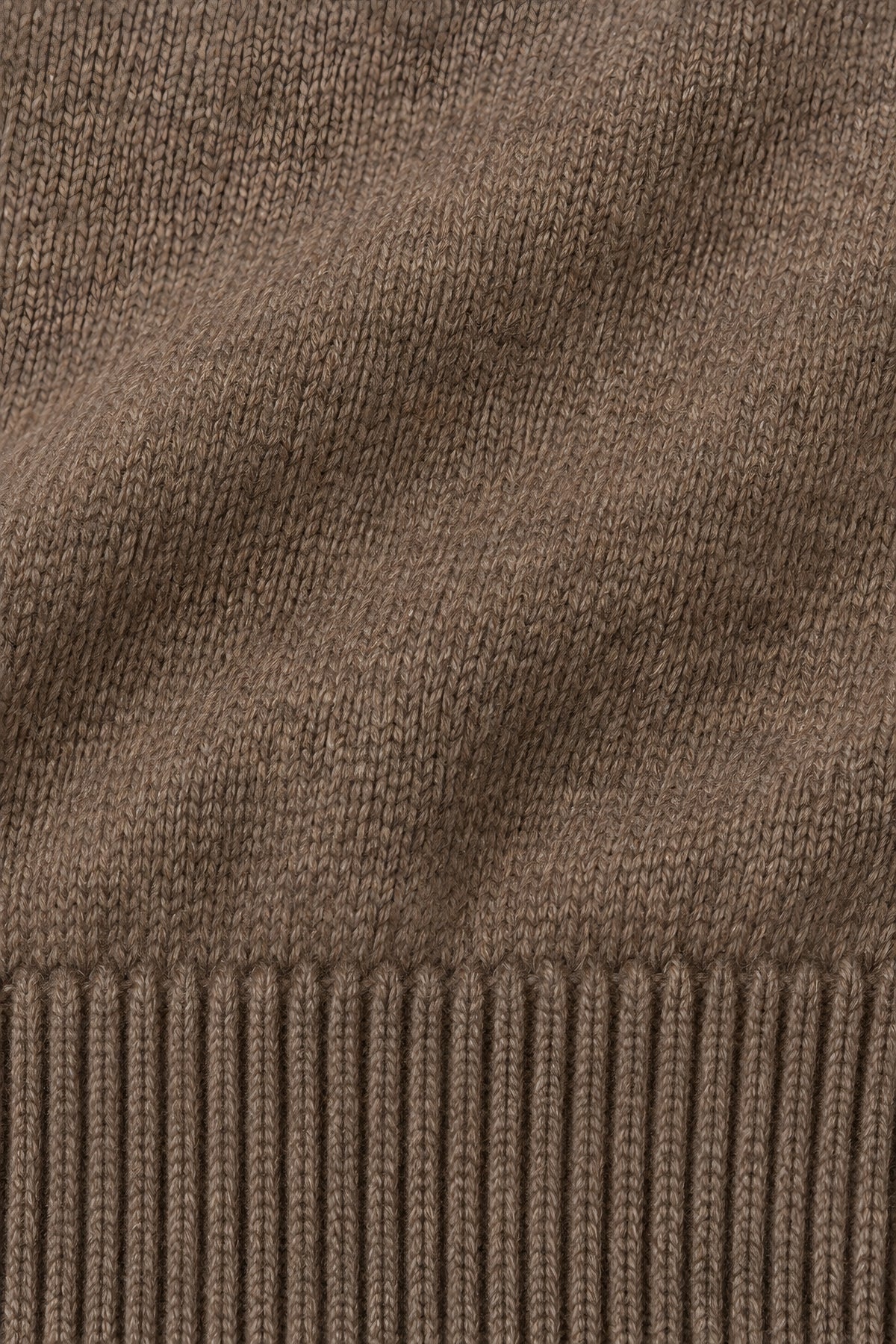 Pull col rond Socle café, macro de la matière — visuel généré par IA